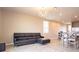 Comfortable living room featuring tile flooring and an open layout to the kitchen and dining areas at 30498 Pintail Dr, Leesburg, FL 34748