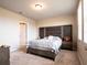 Cozy main bedroom with carpet, neutral walls, and an ensuite bathroom for comfort and privacy at 30498 Pintail Dr, Leesburg, FL 34748