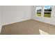 Cozy bedroom with carpet, neutral walls, and views of the outdoors at 3053 Daffodil Dr, Lake Hamilton, FL 33851