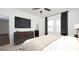 Main bedroom with luxury bed, dark wood dresser, TV, and stylish decor at 3053 Daffodil Dr, Lake Hamilton, FL 33851