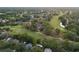 Wide aerial view of neighborhood, showing golf course, mature trees, and residential area at 311 Needles Trl, Longwood, FL 32779