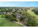 Aerial view of neighborhood highlighting the lush landscaping, community golf course, and nearby waterways at 311 Needles Trl, Longwood, FL 32779
