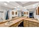 Bright bathroom featuring a large mirror and bamboo cabinetry with dual sinks at 311 Needles Trl, Longwood, FL 32779