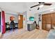 Bedroom featuring a desk and gaming chair, with hardwood floors, wooden door and ceiling fan at 311 Needles Trl, Longwood, FL 32779