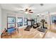 Bright exercise room with wood floors, mirrored wall, and multiple windows at 311 Needles Trl, Longwood, FL 32779
