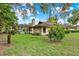 Exterior view of house featuring lush landscaping and screened-in pool, perfect for relaxing and enjoying outdoors at 311 Needles Trl, Longwood, FL 32779