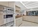 Bright kitchen featuring stainless steel double ovens, cooktop, and stone countertops at 311 Needles Trl, Longwood, FL 32779