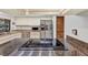 Kitchen island with cooktop, stainless steel appliances, stone countertops, and natural wood accents at 311 Needles Trl, Longwood, FL 32779