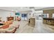 Open concept living room with fireplace, tile flooring, kitchen bar and sliding doors with a pool view at 311 Needles Trl, Longwood, FL 32779