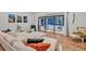 Bright living room features hardwood floors, comfortable white furniture and sliding glass doors to the pool at 311 Needles Trl, Longwood, FL 32779