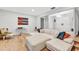 Spacious living room featuring hardwood floors, a large sectional, and a bright and airy atmosphere at 311 Needles Trl, Longwood, FL 32779