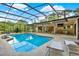 Inviting screened-in pool area with ample seating, outdoor dining, and a built-in bar for relaxing and entertaining at 311 Needles Trl, Longwood, FL 32779