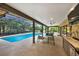 Inviting screened-in pool area with outdoor seating, dining, and a convenient bar for poolside entertaining at 311 Needles Trl, Longwood, FL 32779