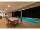Beautiful outdoor patio with dining, seating and summer kitchen overlooking sparkling screened-in pool at 311 Needles Trl, Longwood, FL 32779