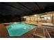 Screened-in pool at night with ample patio space and outdoor kitchen, perfect for relaxing and entertaining at 311 Needles Trl, Longwood, FL 32779