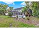 Exterior view of screened pool and patio area surrounded by beautiful landscaping and lush green grass at 311 Needles Trl, Longwood, FL 32779