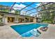 Backyard pool and patio area featuring a screen enclosure, outdoor seating, dining, and outdoor bar at 311 Needles Trl, Longwood, FL 32779