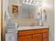 A bright bathroom with a wooden vanity, ample lighting, and built in storage at 3131 Juniper Dr, Edgewater, FL 32141