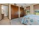 Cozy bedroom featuring a patterned quilt, neutral carpet, and ample closet space for storage at 3131 Juniper Dr, Edgewater, FL 32141