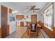 Cozy dining area featuring a wooden table, wood paneling, and a ceiling fan at 3131 Juniper Dr, Edgewater, FL 32141