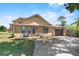 Inviting two-story home with a well-maintained lawn, driveway, and cozy front porch with seating at 3131 Juniper Dr, Edgewater, FL 32141
