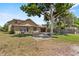 Charming brown two-story home with mature trees, a driveway, and a welcoming front yard at 3131 Juniper Dr, Edgewater, FL 32141