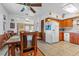 Kitchen with wood cabinets, white appliances, and eat in kitchen at 3131 Juniper Dr, Edgewater, FL 32141