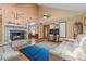 Open-concept living area showcasing a fireplace, hardwood floors, and ample natural light at 3131 Juniper Dr, Edgewater, FL 32141