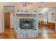 Close-up of a living room fireplace and view into an adjacent dining area at 3131 Juniper Dr, Edgewater, FL 32141