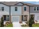 Charming townhome showcases a well-manicured lawn and a one-car garage at 3394 Vesara Dr, Davenport, FL 33837