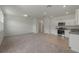 Bright open-concept living space featuring carpeting, tile, and stainless steel appliances at 3394 Vesara Dr, Davenport, FL 33837
