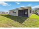 View of backyard featuring lawn, screen lanai and partial view of side of house at 3397 Sagebrush St, Harmony, FL 34773