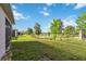 Well-manicured backyard with a view of mature trees and a tranquil lake at 3397 Sagebrush St, Harmony, FL 34773