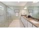 Bathroom featuring double sinks, white cabinets, and a glass enclosed shower with tiled walls at 3397 Sagebrush St, Harmony, FL 34773