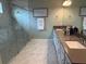 Elegant bathroom with double vanity, granite countertop, and modern glass-enclosed shower at 3397 Sagebrush St, Harmony, FL 34773