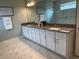 Elegant bathroom with double vanity, granite countertop, and modern glass-enclosed shower at 3397 Sagebrush St, Harmony, FL 34773