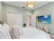Serene bedroom with a mounted TV, cozy seating and closet with double doors at 3397 Sagebrush St, Harmony, FL 34773