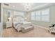 Bright bedroom with a chandelier, plantation shutters, and a bench at 3397 Sagebrush St, Harmony, FL 34773