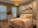 Cozy bedroom with shuttered windows, modern lighting, and comfortable furnishings at 3397 Sagebrush St, Harmony, FL 34773