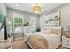 Charming bedroom featuring a cozy bed with stylish linens and a decorative chandelier at 3397 Sagebrush St, Harmony, FL 34773