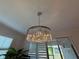 Elegant crystal chandelier with silver hardware and lighting in a light and airy room at 3397 Sagebrush St, Harmony, FL 34773