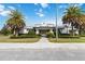 Exterior view of clubhouse with manicured landscaping and palm trees at 3397 Sagebrush St, Harmony, FL 34773