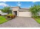 Beautiful home with a well-manicured lawn and landscaped front yard and a brick driveway at 3397 Sagebrush St, Harmony, FL 34773