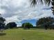 Scenic view of the green golf course with lush trees and clear sky at 3397 Sagebrush St, Harmony, FL 34773