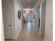 Bright hallway featuring neutral paint, a tray ceiling, and decorative details throughout at 3397 Sagebrush St, Harmony, FL 34773