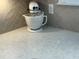 Kitchenaid mixer sits on the kitchen's beautiful quartz countertop and herringbone backsplash at 3397 Sagebrush St, Harmony, FL 34773