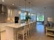 Bright, open kitchen with a large center island, pendant lighting, and stainless steel appliances at 3397 Sagebrush St, Harmony, FL 34773