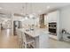 A modern white kitchen features stainless steel appliances and an island at 3397 Sagebrush St, Harmony, FL 34773