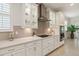 Modern kitchen features stainless steel appliances, white cabinetry, and quartz countertops at 3397 Sagebrush St, Harmony, FL 34773