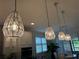 Kitchen showcases pendant lighting, white cabinetry, and stainless steel appliances at 3397 Sagebrush St, Harmony, FL 34773